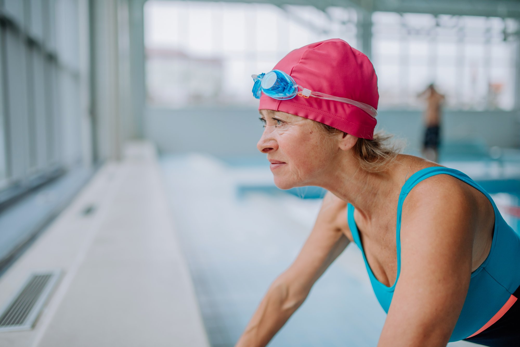 active-senior-woman-preapring-for-swim-in-indoors-2023-11-27-05-35-18-utc